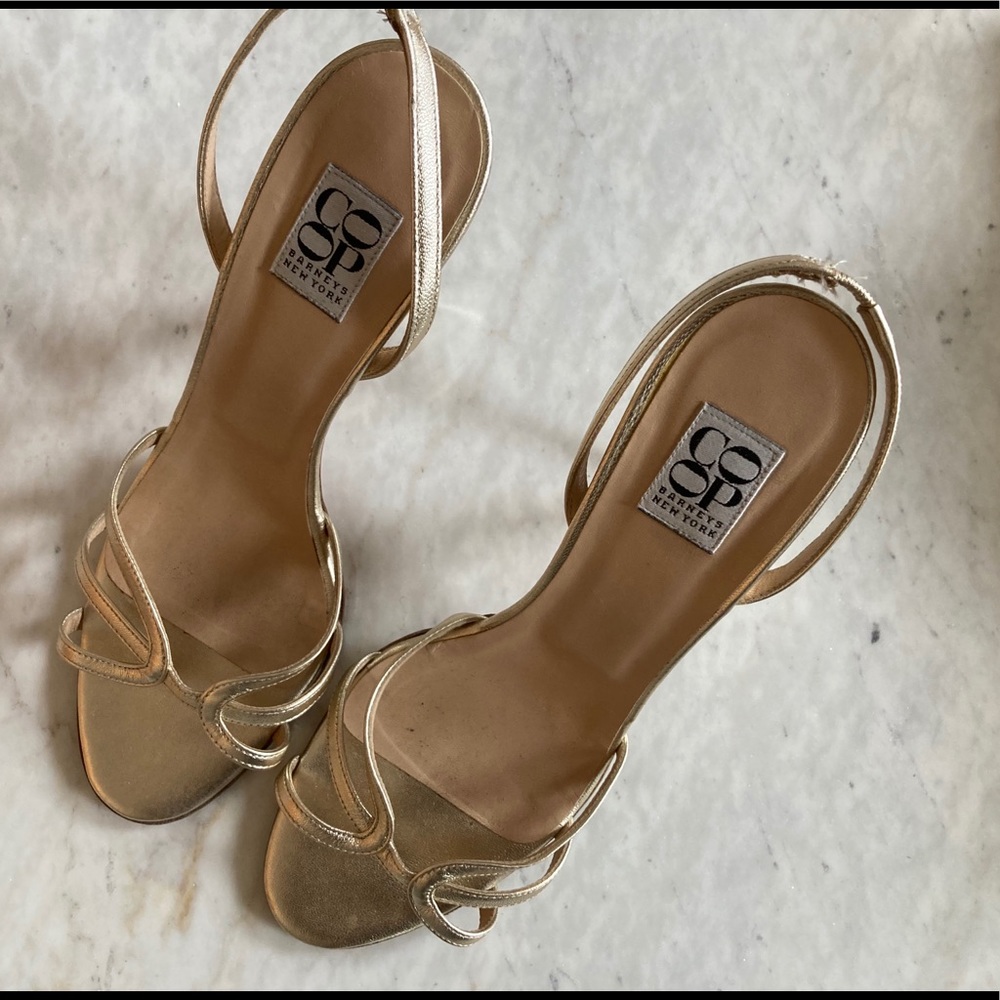 Barney’s New York coop gold high heeled sandals.